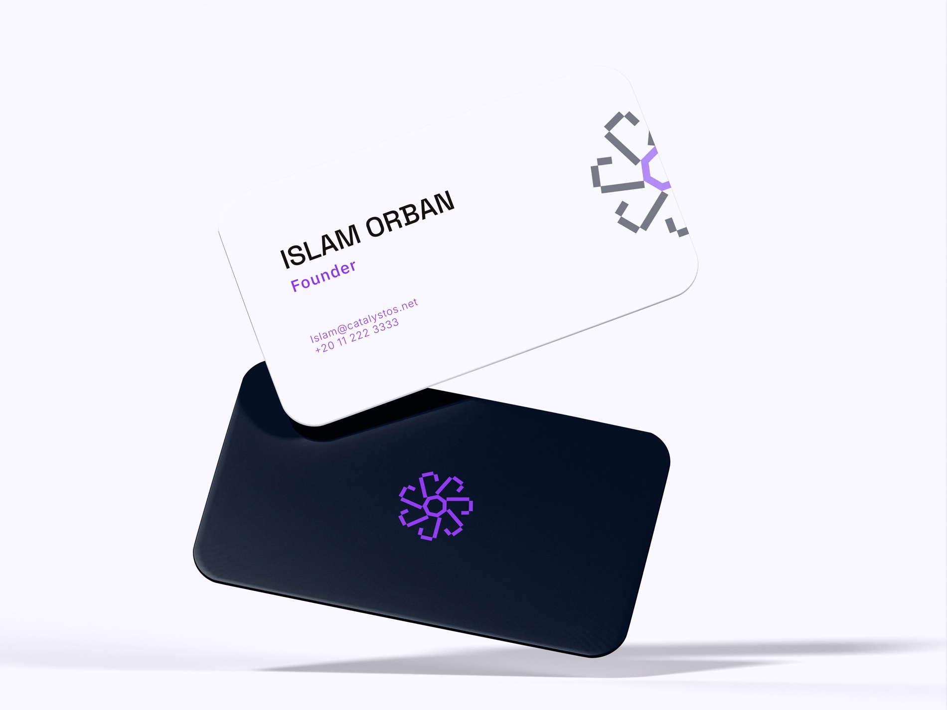 Catalyst business cards — a Void-black card with the violet nucleus mark, and an Aura-white card.