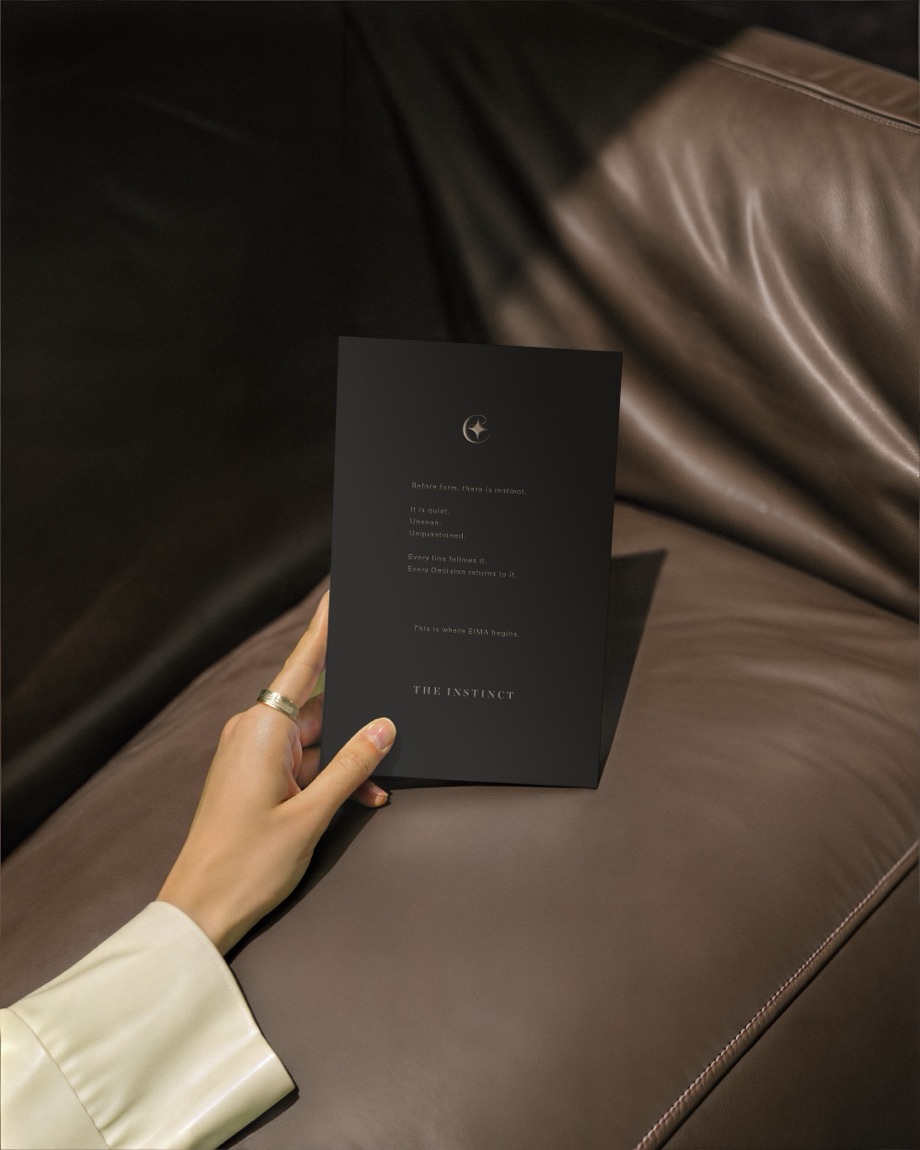 EIMA — The Instinct card on a leather couch