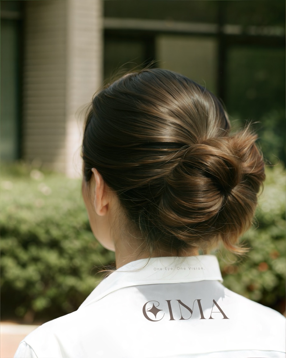 EIMA — logo collar in a sunlit courtyard