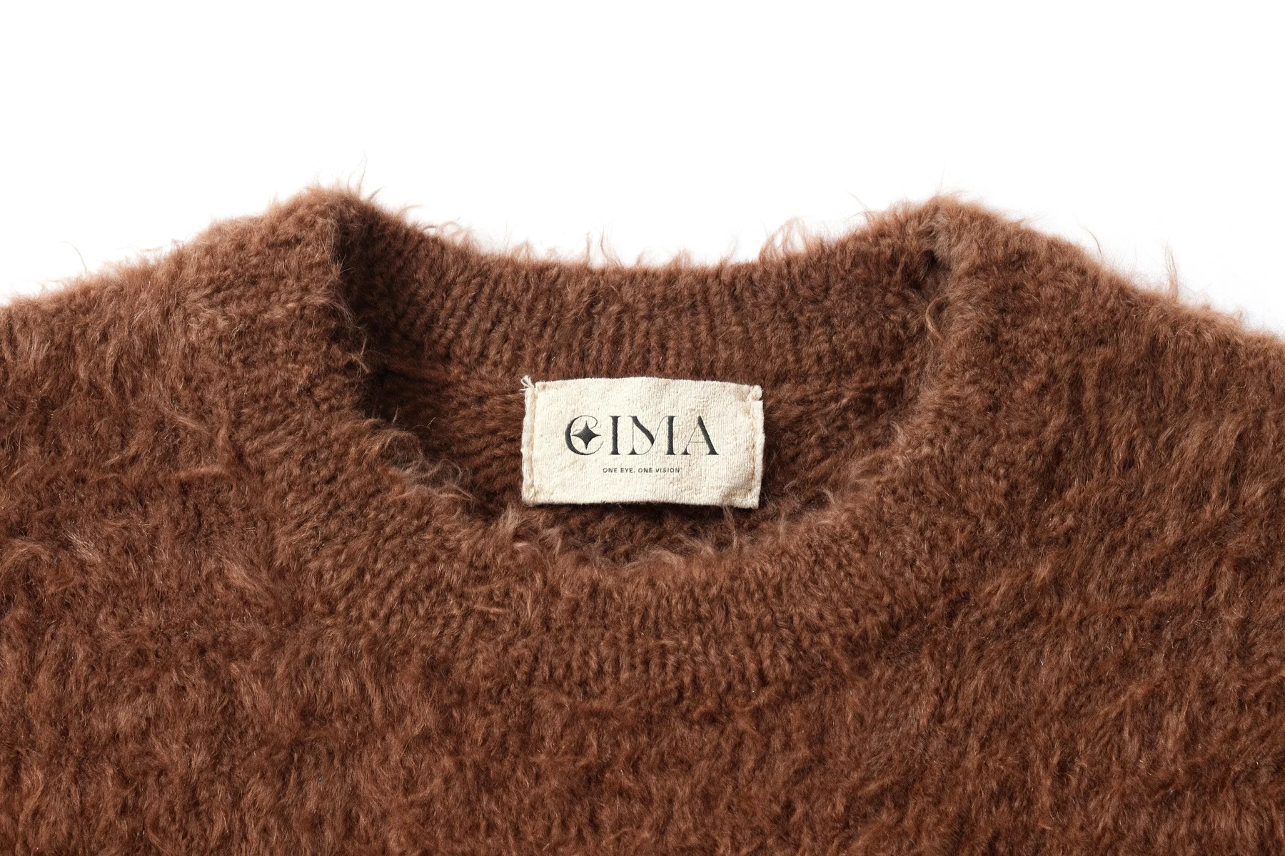 EIMA — woven neck label on a mohair knit