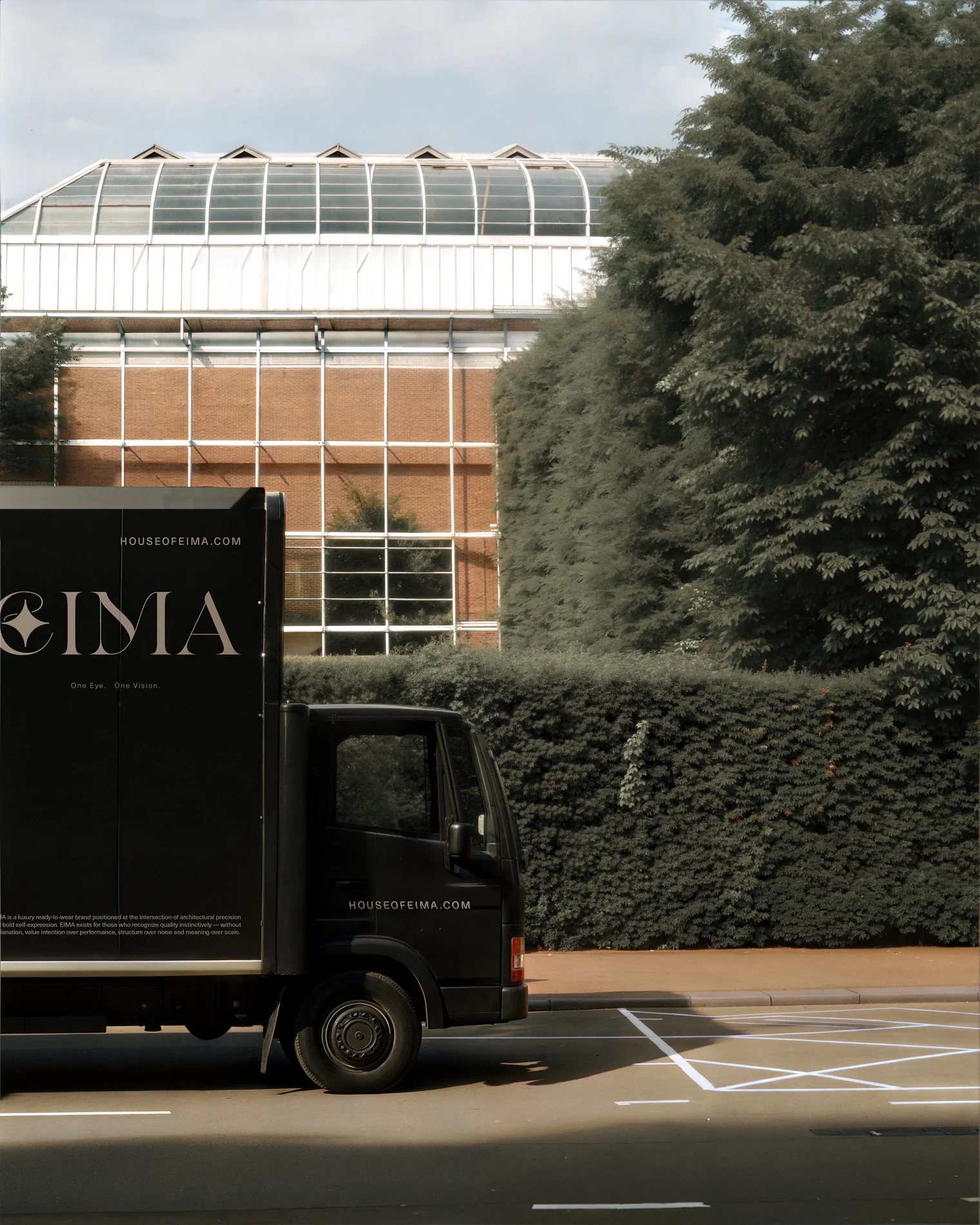 EIMA — a matte-black branded delivery truck