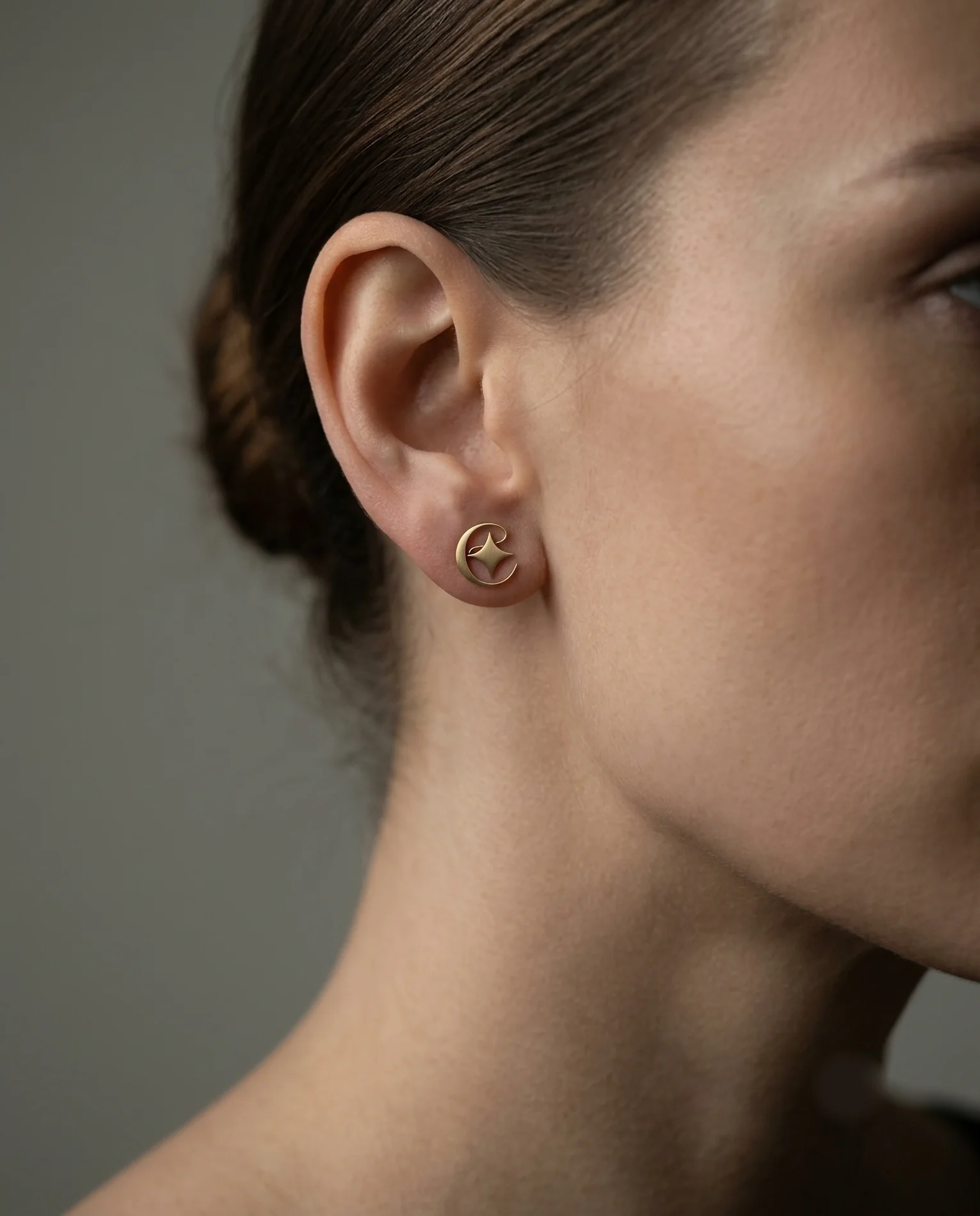 EIMA — the monogram as a gold logo stud earring