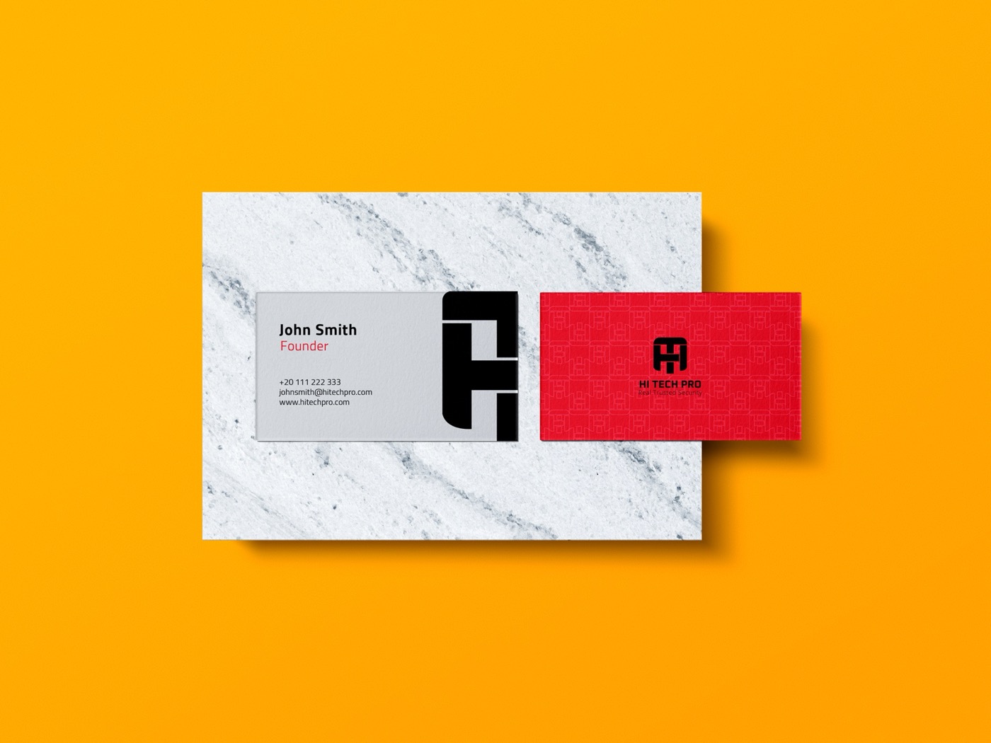 Hi Tech Pro business cards — a marble front and a red back carrying the pattern