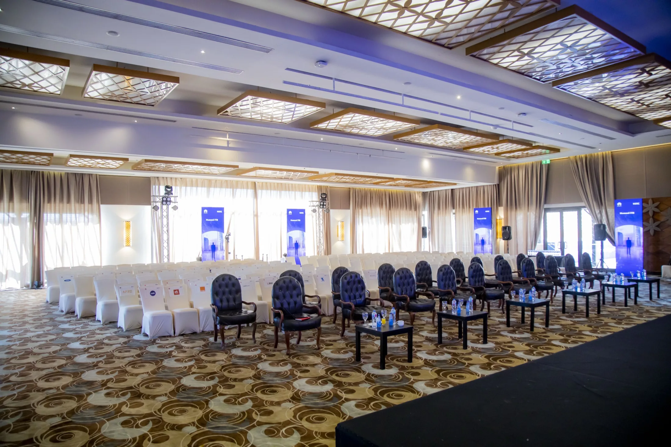 VIP round-table hospitality set under violet uplighting