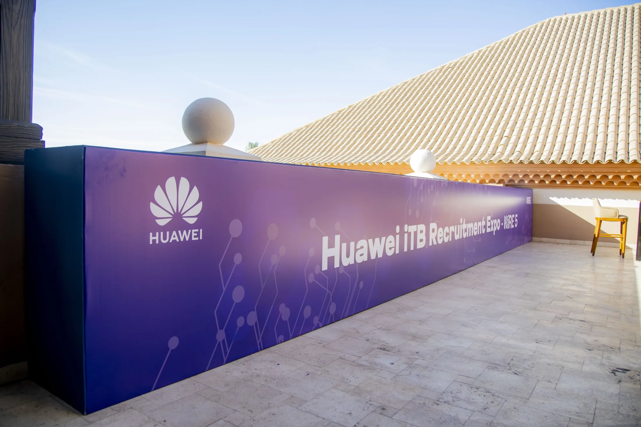 A long Huawei iTB Recruitment Expo branding wall receding in perspective