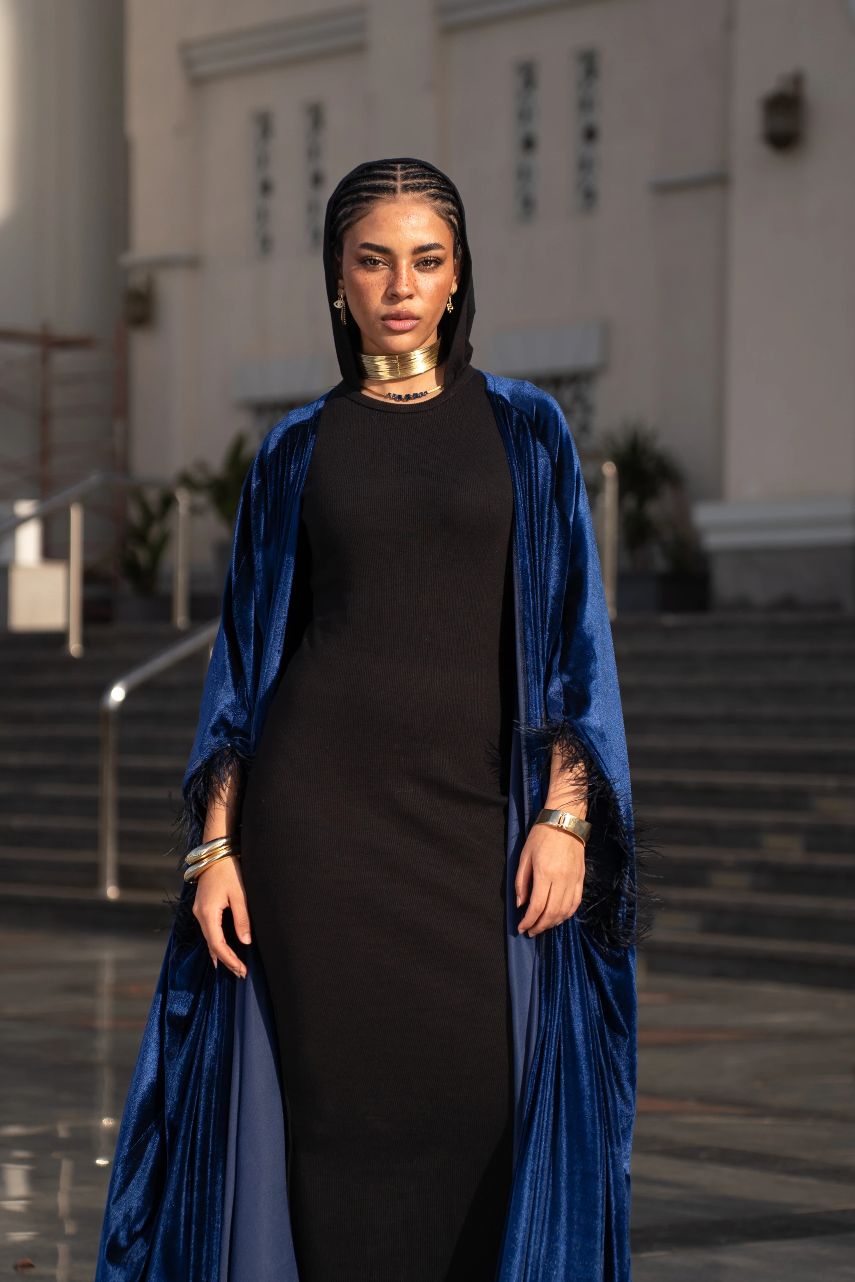 Khawia — a sheer black evening gown in a quiet studio