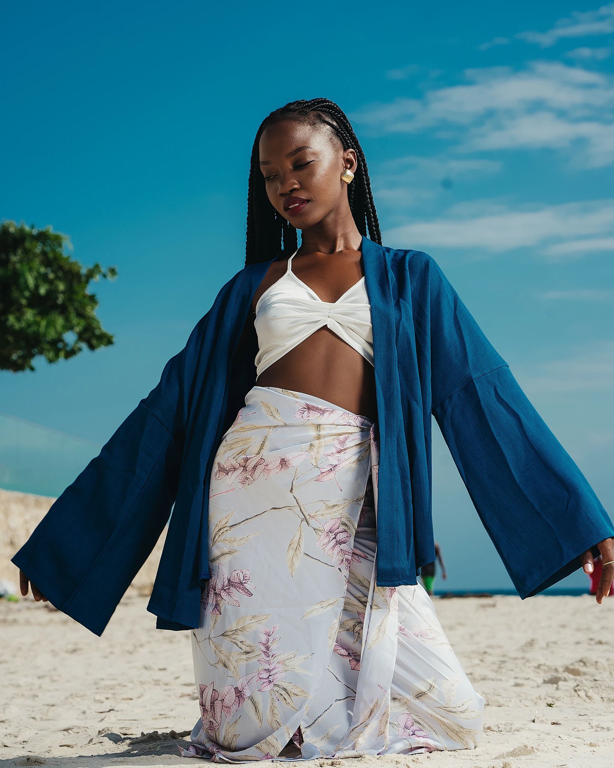 Khokha — a navy kimono and white crop with a painterly wrap by the shore, Zanzibar