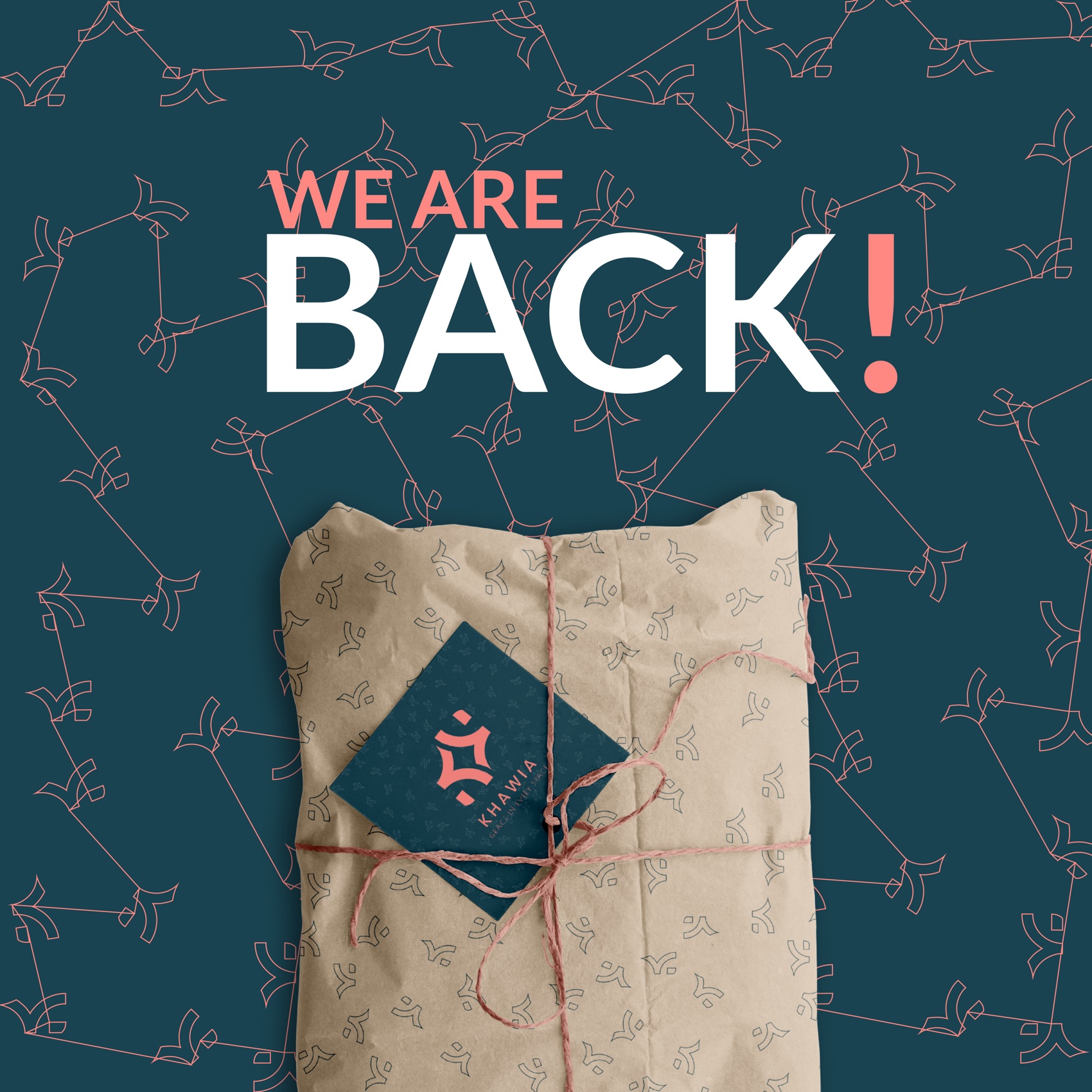 Khawia — the 'We Are Back' announcement: petrol ground, coral constellation pattern, a kraft parcel tied with coral twine and the brand card